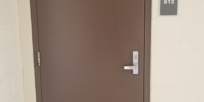 A plain, brown classroom door.